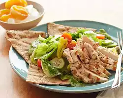 Grilled chicken salad with whole-wheat pita bread