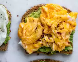 Scrambled eggs with whole-wheat toast and avocado slices